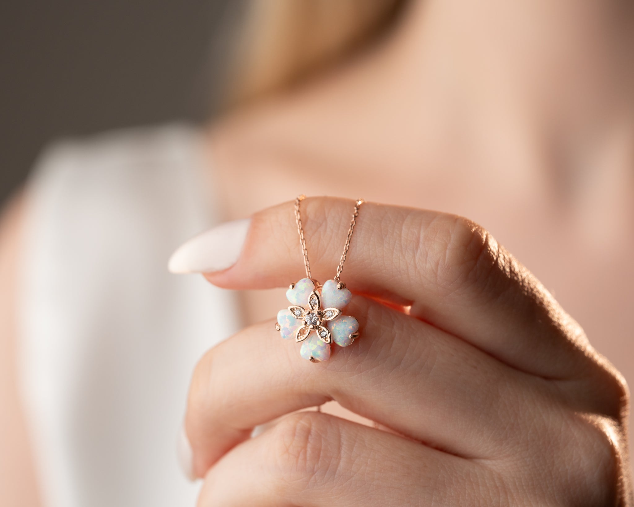 A nature-inspired necklace with a luminous opal flower pendant, capturing the magic of floral jewelry.